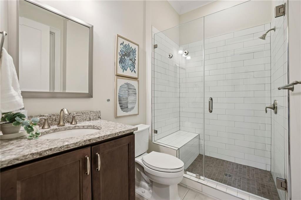 7345 Samples Field Road Cumming, GA 30040 - Photo 18 of 29 a bathroom with a granite countertop sink toilet and shower