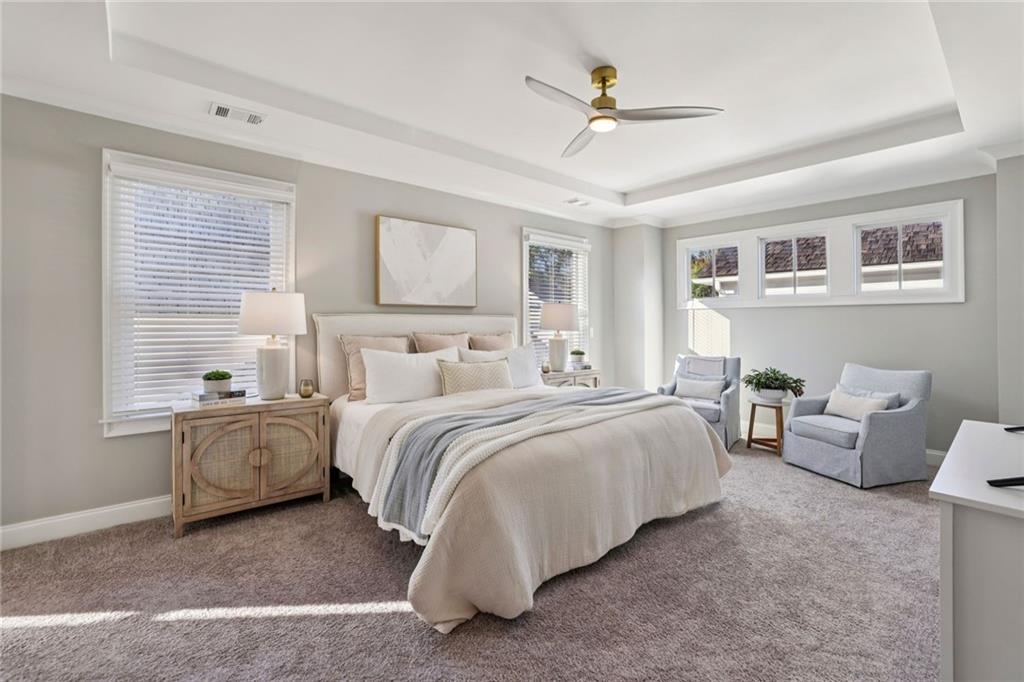 7345 Samples Field Road Cumming, GA 30040 - Photo 20 of 29 a spacious bedroom with a bed and a chandelier