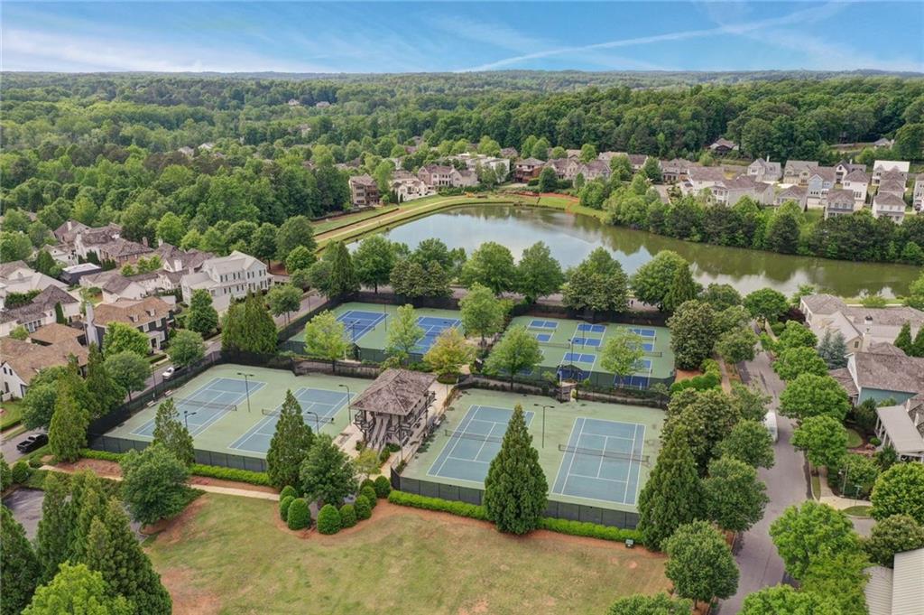 7345 Samples Field Road Cumming, GA 30040 - Photo 28 of 29 an aerial view of residential houses with outdoor space and lake view