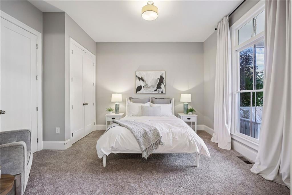 7345 Samples Field Road Cumming, GA 30040 - Photo 8 of 29 a spacious bedroom with a bed and a window