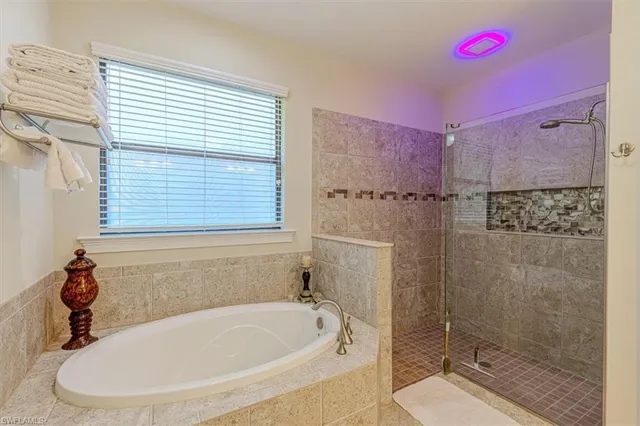 a bath tub sitting next to a bathroom sink