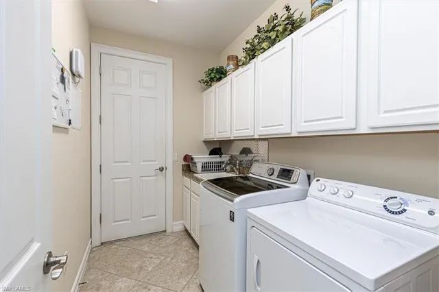 a view of a storage and utility room with washer and dryer