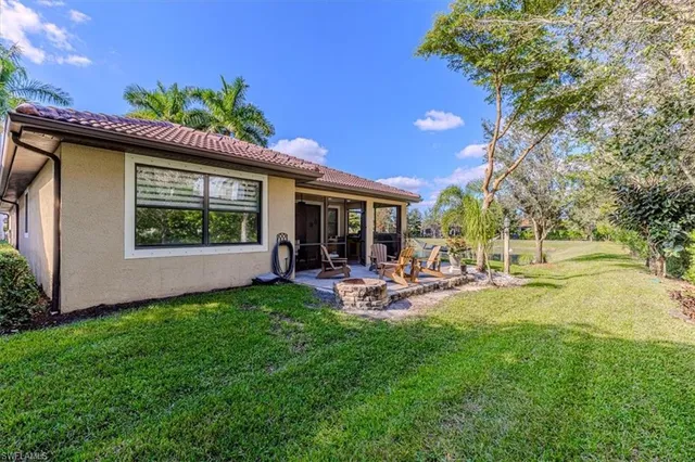 a view of a house with backyard porch and sitting area