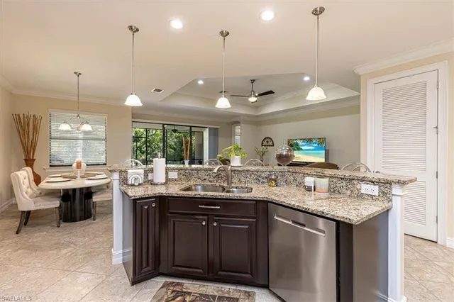 a kitchen with a sink and living room view