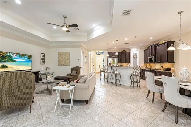 a living room with furniture and kitchen view