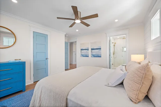 a bedroom with a large bed and a ceiling fan
