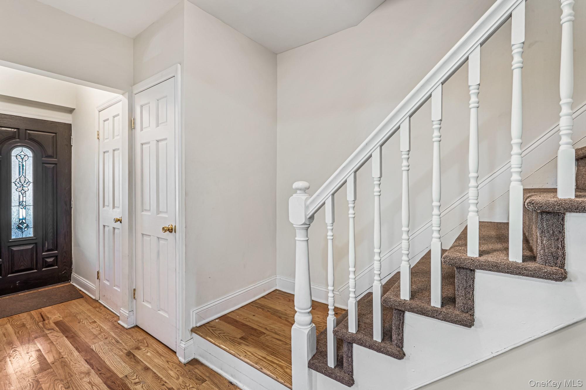 61-12 Main Street Queens, NY 11367 - Photo 15 of 35 Foyer entrance featuring stairs and light wood-style floors
