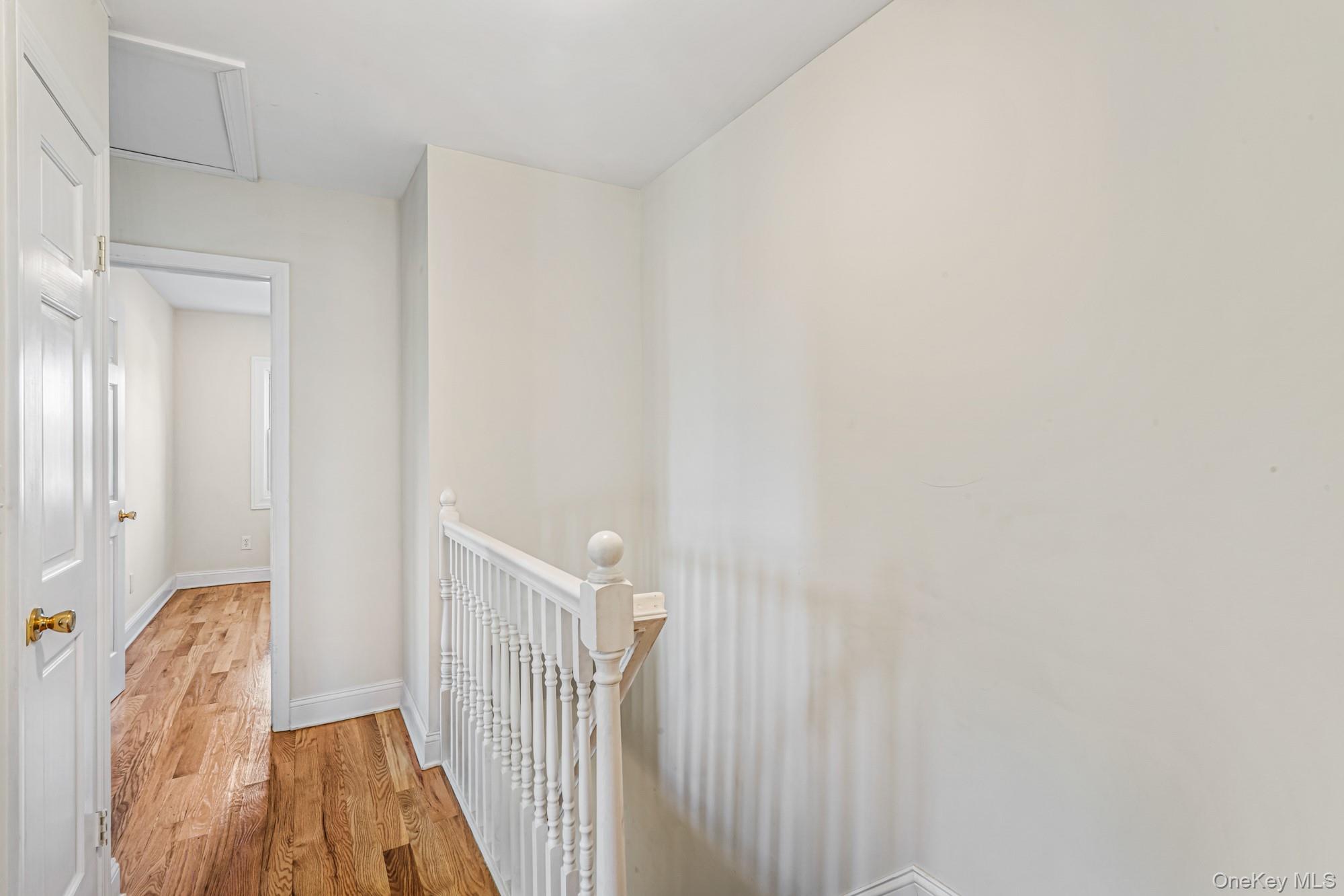 61-12 Main Street Queens, NY 11367 - Photo 22 of 35 Corridor featuring light wood-style flooring and an upstairs landing