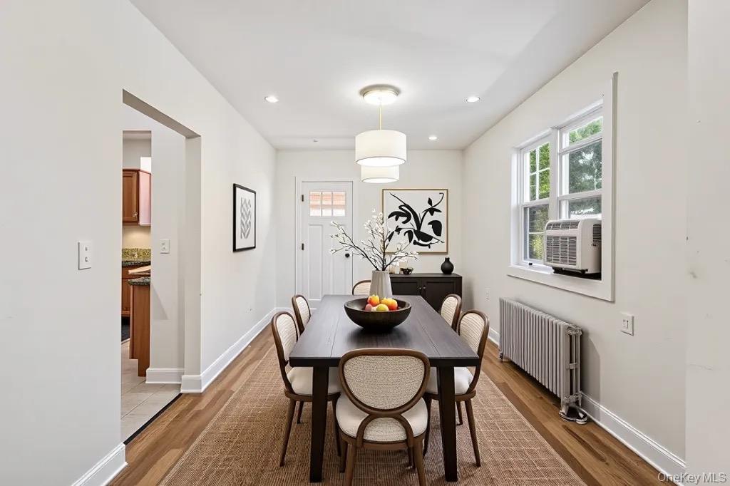 61-12 Main Street Queens, NY 11367 - Photo 4 of 35 Dining room featuring healthy amount of natural light, radiator, light wood-style floors, and recessed lighting