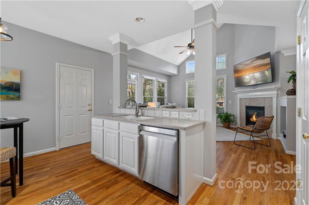 412 Third Baxter Street Fort Mill, SC 29708 - Photo 14 of 39 a large kitchen with cabinets wooden floor and a fireplace