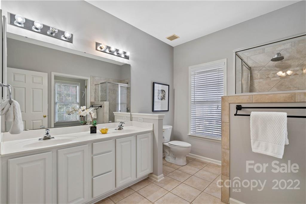 412 Third Baxter Street Fort Mill, SC 29708 - Photo 25 of 39 a spacious bathroom with a double vanity sink a mirror and toilet