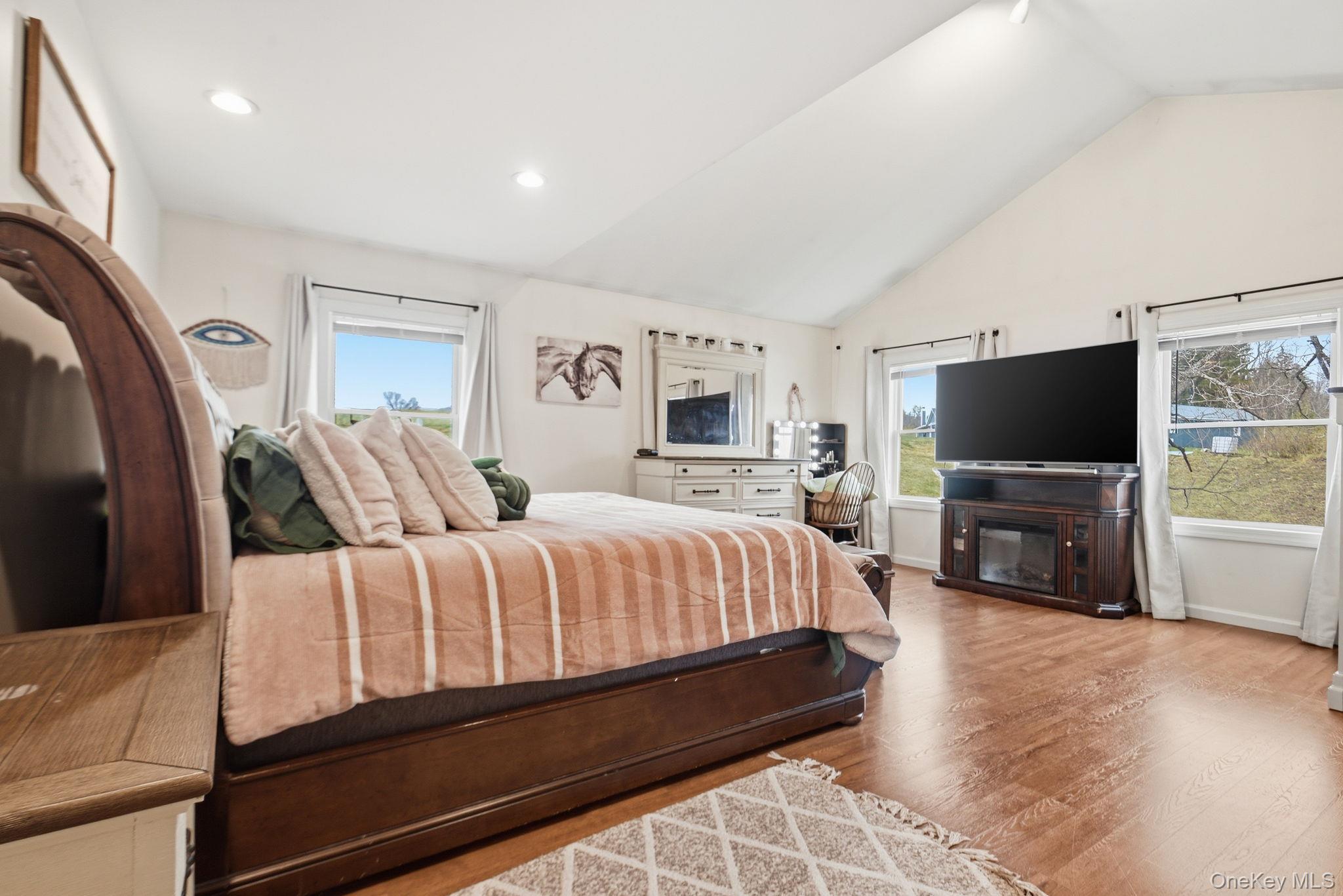41 Beilke Road Millerton, NY 12546 - Photo 21 of 26 a spacious bedroom with a bed and a flat screen tv