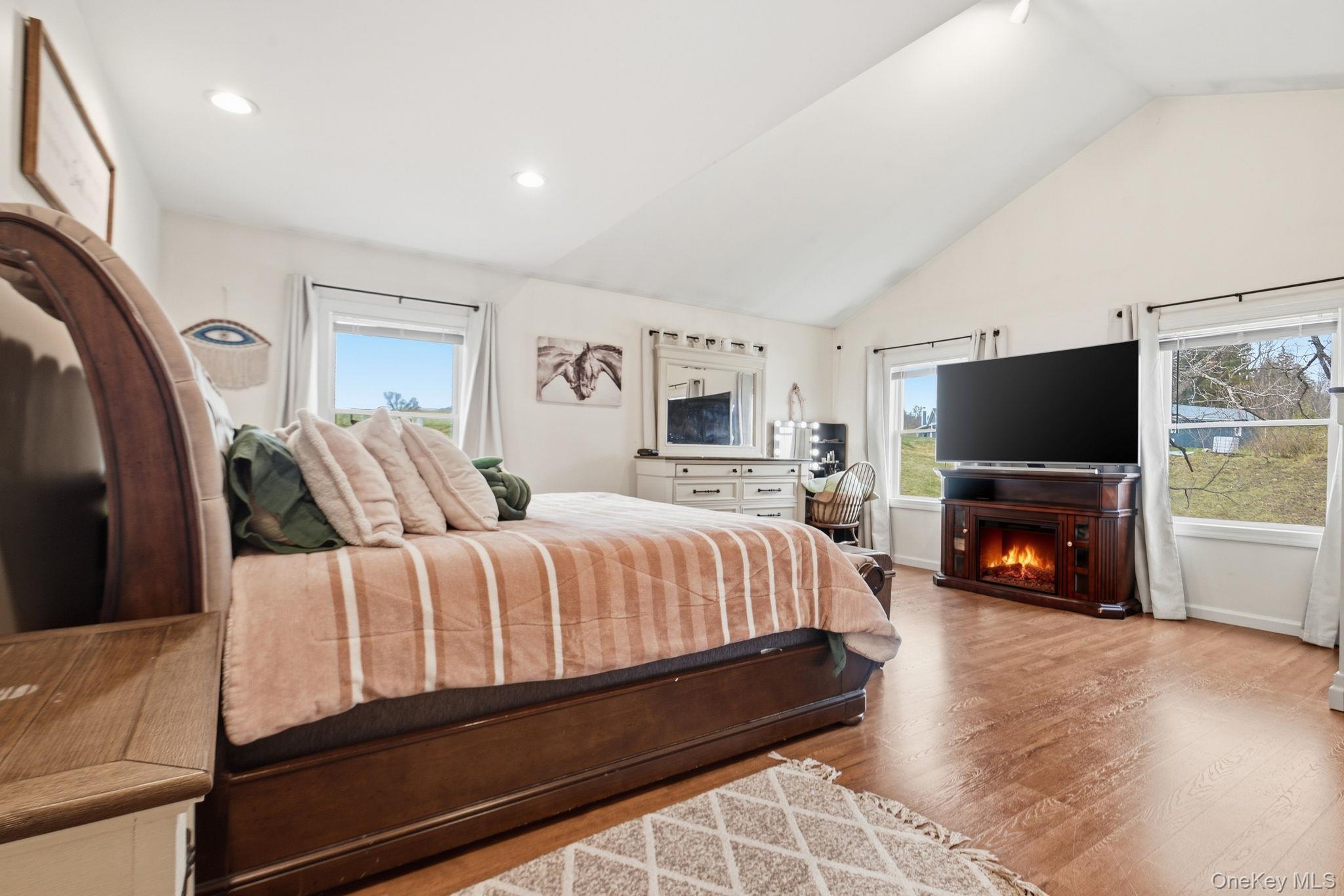 41 Beilke Road Millerton, NY 12546 - Photo 22 of 26 a spacious bedroom with a bed and a flat screen tv