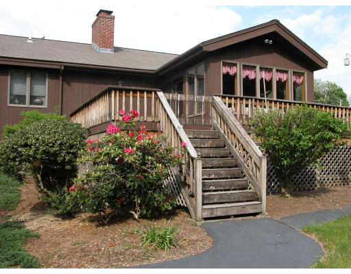 406 Boston Road Groton, MA 01450 - Photo 1 of 13 a front view of a house with a garden