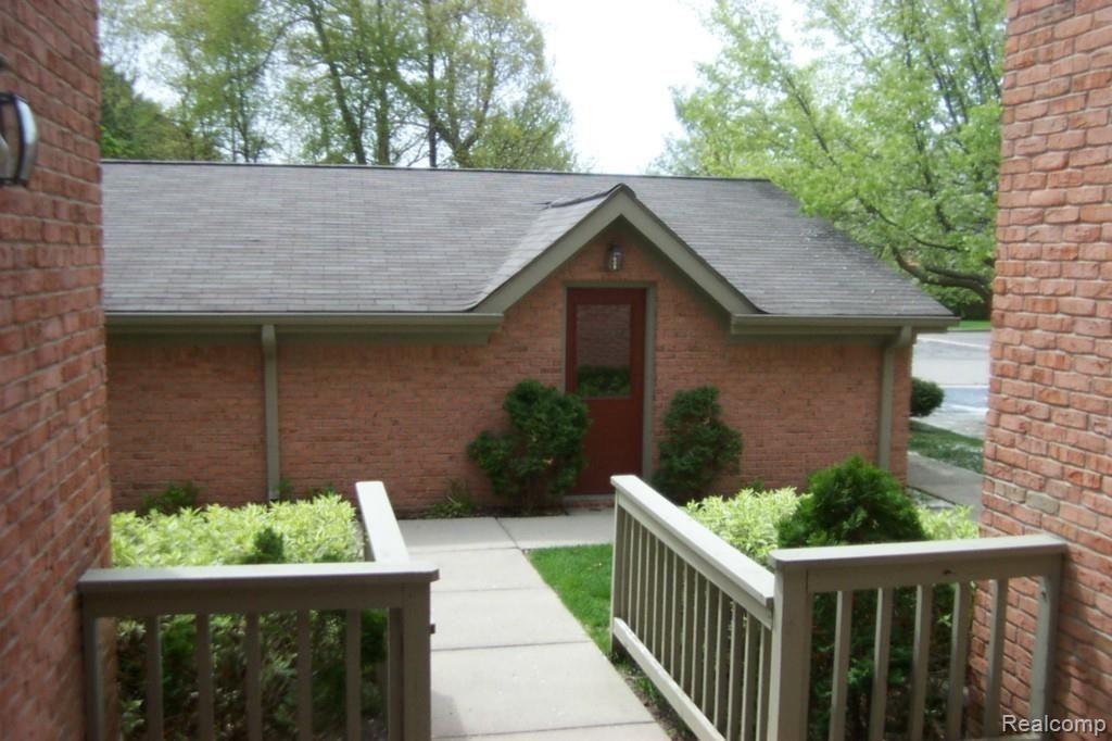 900 Ridge Court, Unit 121 Brighton, MI 48116 - Photo 3 of 19 porch towards garage