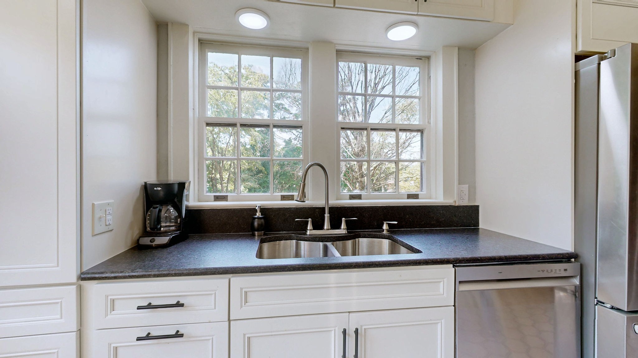 1007 Poplar Street Murray, KY 42071 - Photo 10 of 48 a counter top with granite countertop a sink and a window