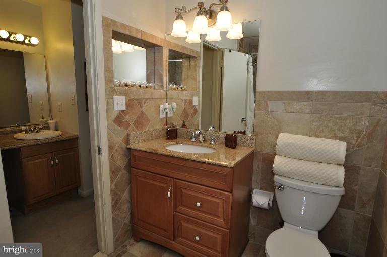 11206 Lagoon Lane Reston, VA 20191 - Photo 9 of 27 a bathroom with a granite countertop toilet sink and mirror