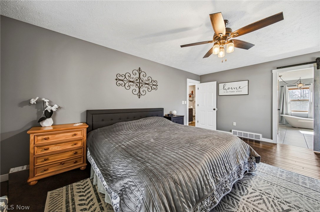 2850 South Ridge Road Perry, OH 44081 - Photo 12 of 41 Bedroom with a textured ceiling, dark wood-type flooring, and ceiling fan
