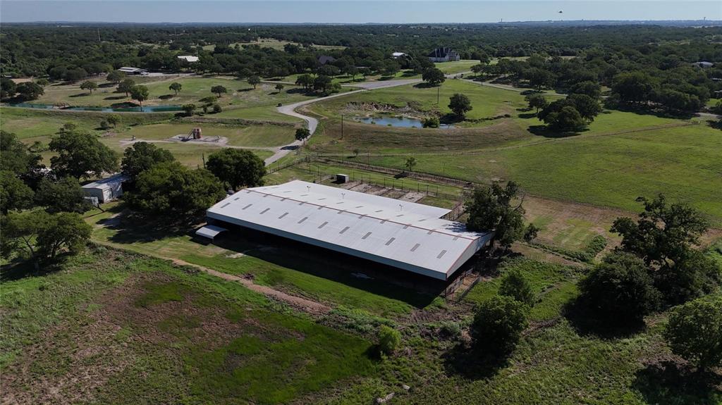 377 Private Road 3249, Unit ARENA Decatur, TX 76234 - Photo 2 of 40 an aerial view of a house with a garden and lake view