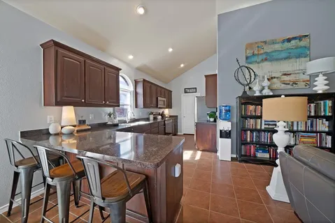 a kitchen with a table chairs and a refrigerator