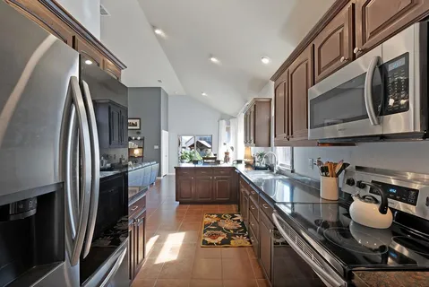 a kitchen with refrigerator and stove