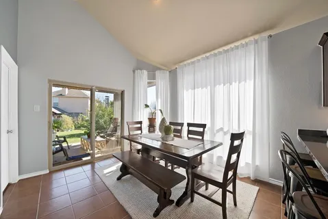 a dining room with furniture and window