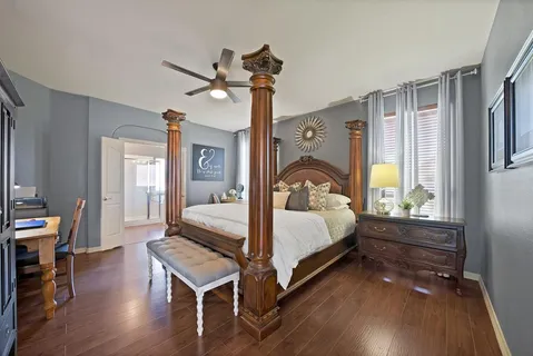 a bedroom with a bed and wooden floor