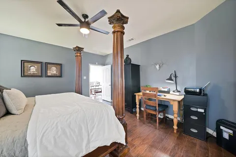 a bedroom with a bed and a desk