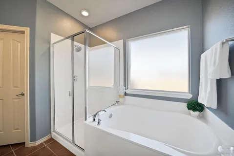a bathroom with a bathtub and a shower