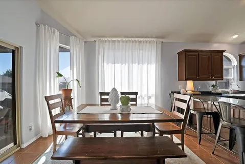 a view of a dining room with furniture window and wooden floor
