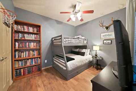 a bedroom with a bed and a book shelf