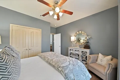 a spacious bedroom with a bed and a chandelier