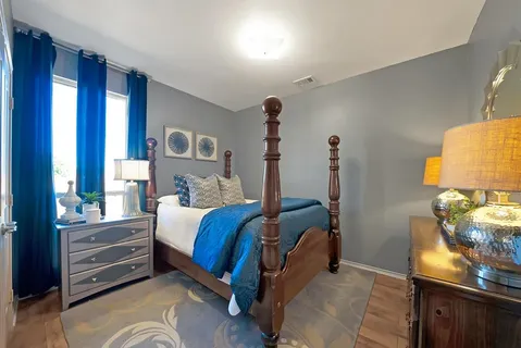 a bed room with a bed and a lamp