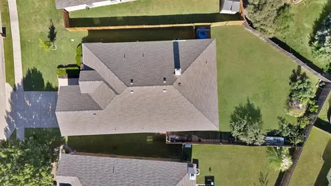 an aerial view of a house with a swimming pool