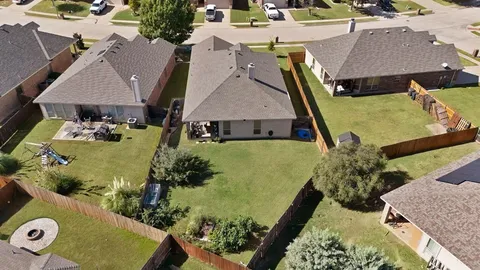 an aerial view of a house with yard swimming pool and outdoor seating