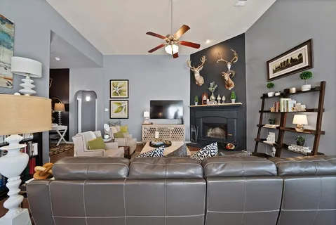a living room with hard wood floor furniture and a fireplace
