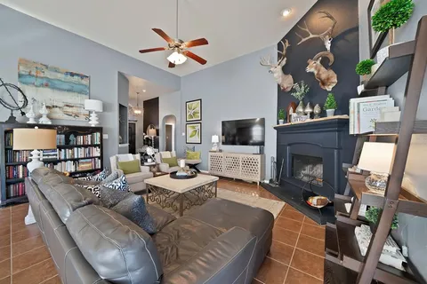 a living room with furniture a flat screen tv and a fireplace