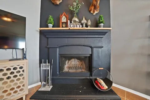 a room with painting on the wall and a potted plant