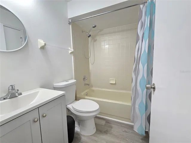 a bathroom with a toilet sink and shower