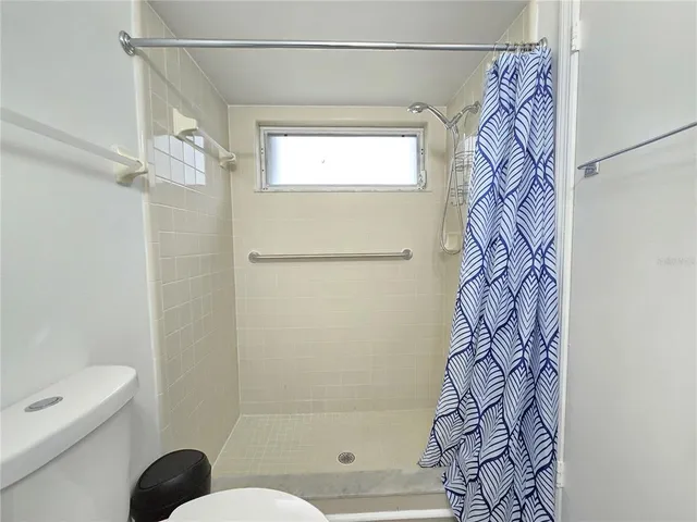 a bathroom with a bathtub and shower