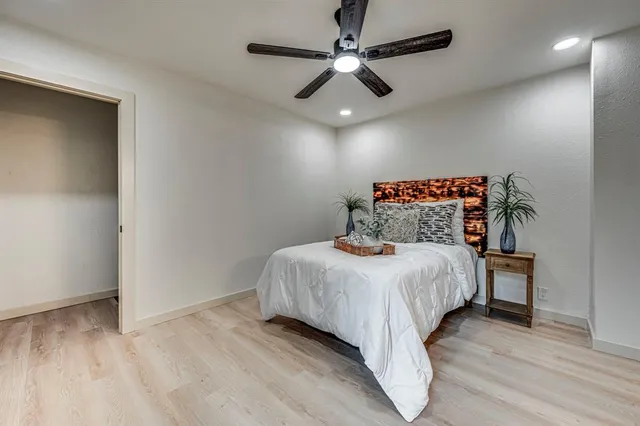 a bedroom with a bed and a ceiling fan