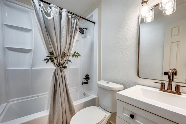 a white toilet sitting next to a bathroom sink