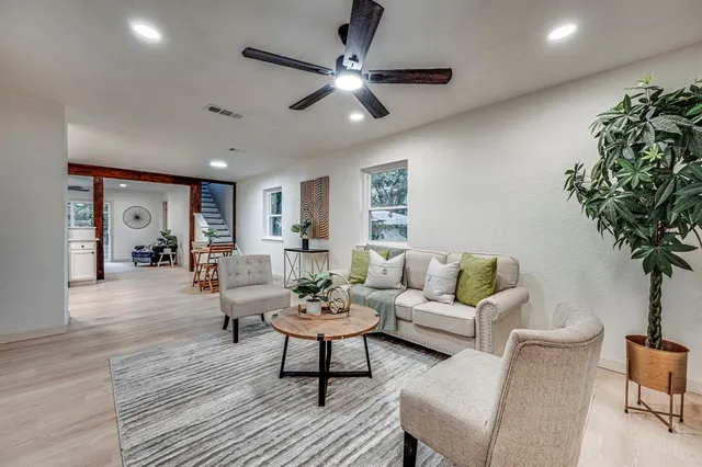 a living room with furniture and a potted plant