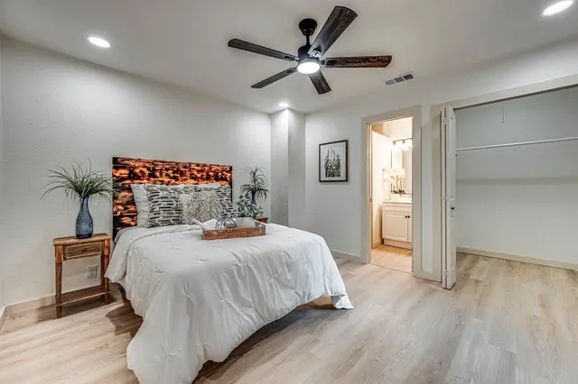 a bedroom with a bed and a ceiling fan