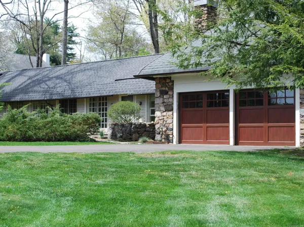 a view of a house with a yard and sitting area