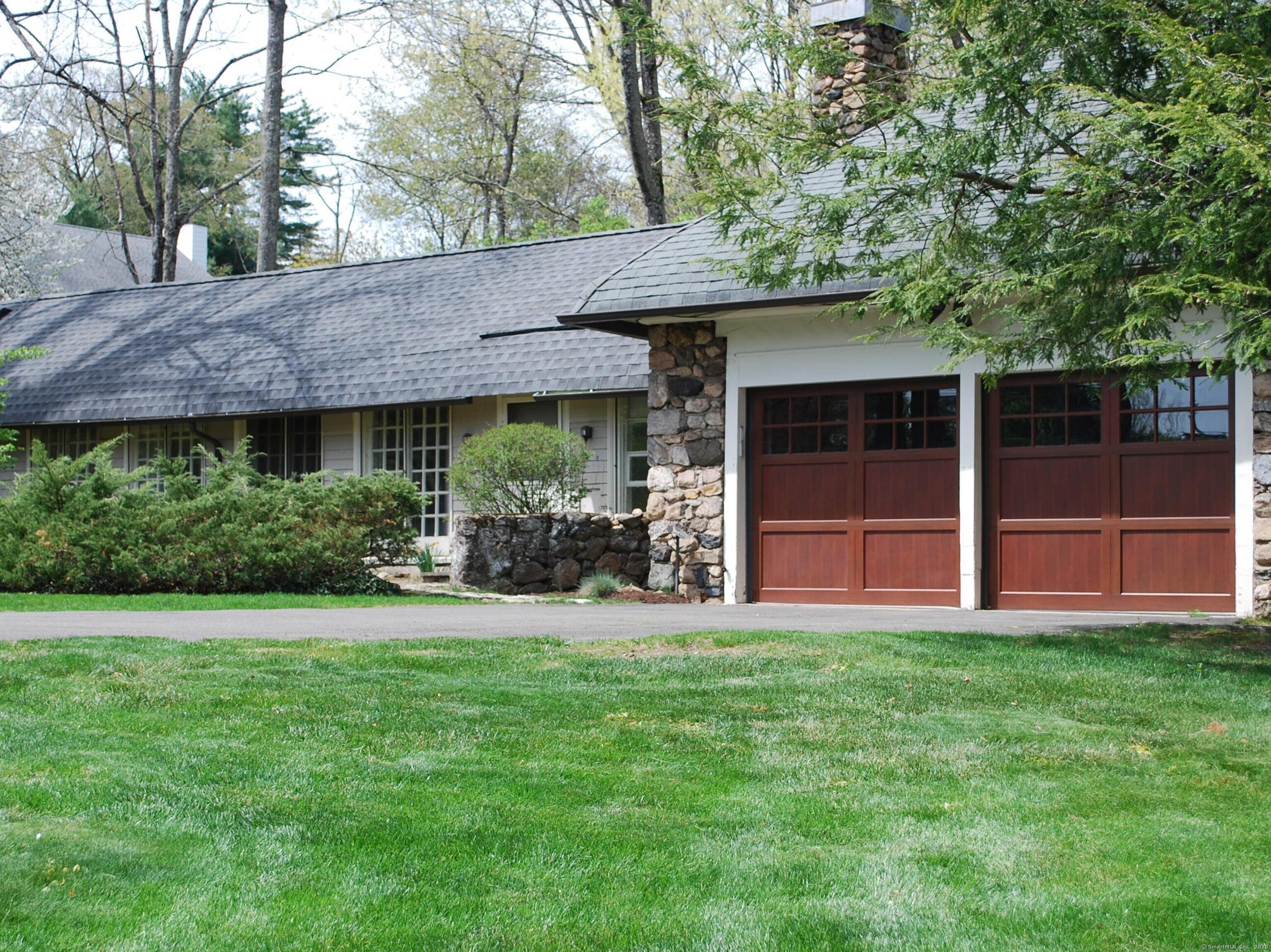 a view of a house with a yard and sitting area