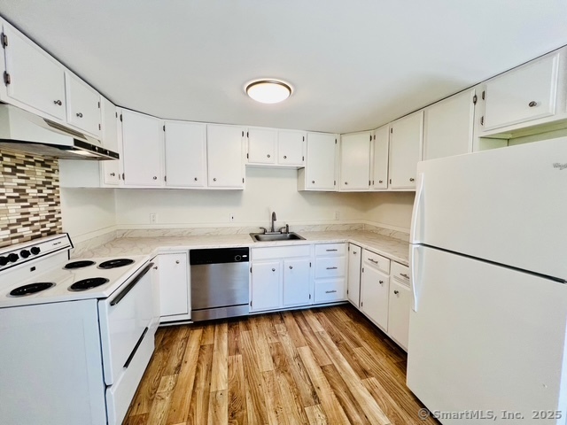 2820 High Ridge Road Stamford, CT 06903 - Photo 6 of 25 a kitchen with cabinets appliances wooden floor and a window