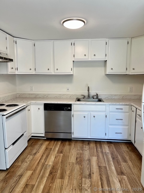 2820 High Ridge Road Stamford, CT 06903 - Photo 8 of 25 a kitchen with granite countertop white cabinets and white appliances
