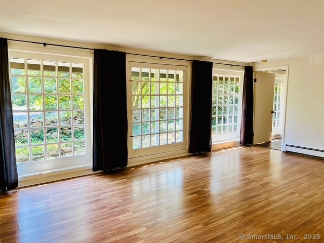 2820 High Ridge Road Stamford, CT 06903 - Photo 9 of 25 a view of an empty room with wooden floor and a window