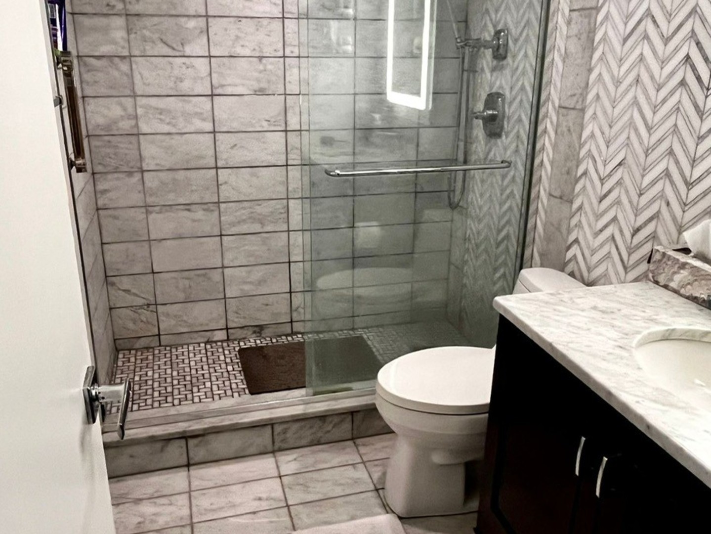 175 East Delaware Place, Unit 4603 Chicago, IL 60611 - Photo 12 of 17 a bathroom with a granite countertop toilet and a sink